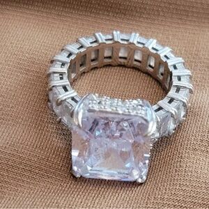 Zircon stone with a 5 carat emerald cut band. 925 solid silver electroplated.